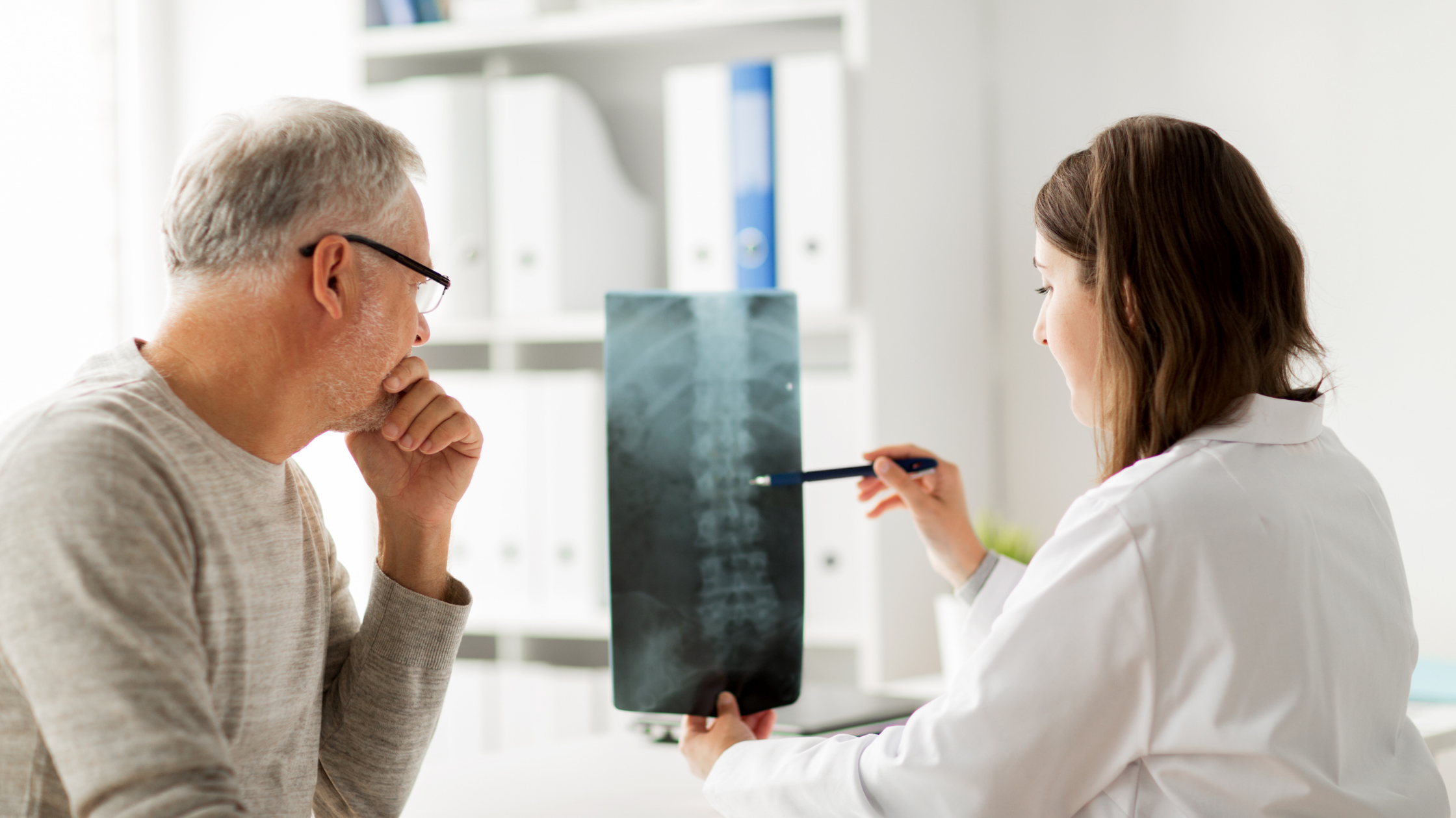 doctor and patient with xray spinal fusion